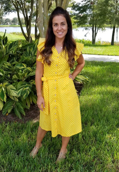 reviewer wearing the yellow version of the dress