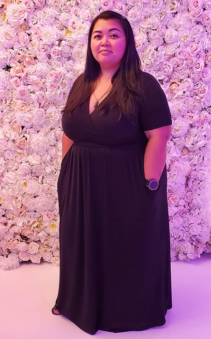 Reviewer in a black maxi dress