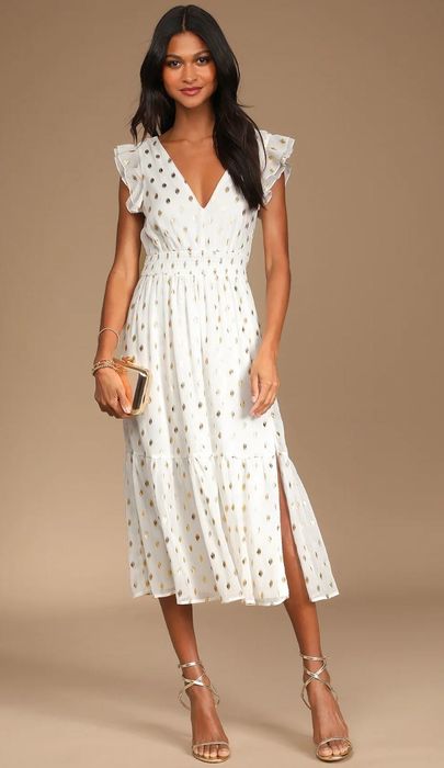 model wearing a stylish white polka dot midi dress