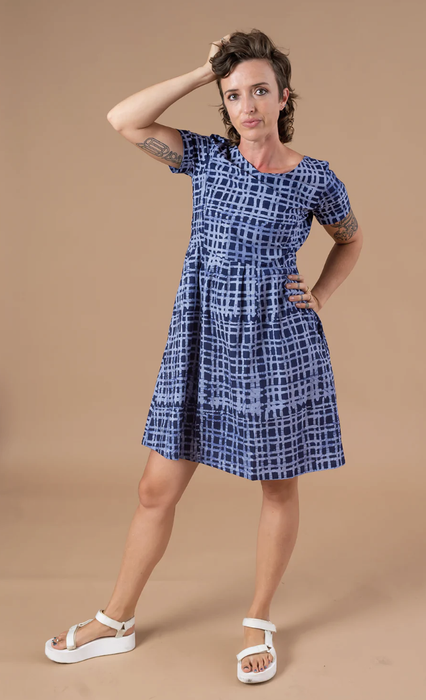 model wearing the dress paired with white sandals