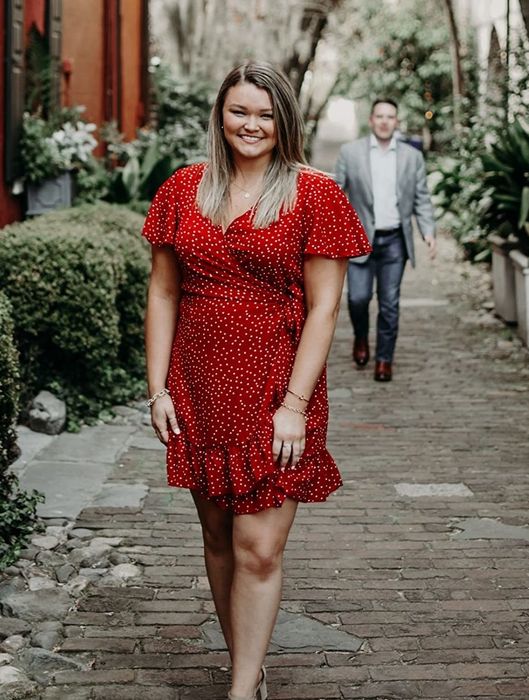 reviewer showcasing the red polka dot dress