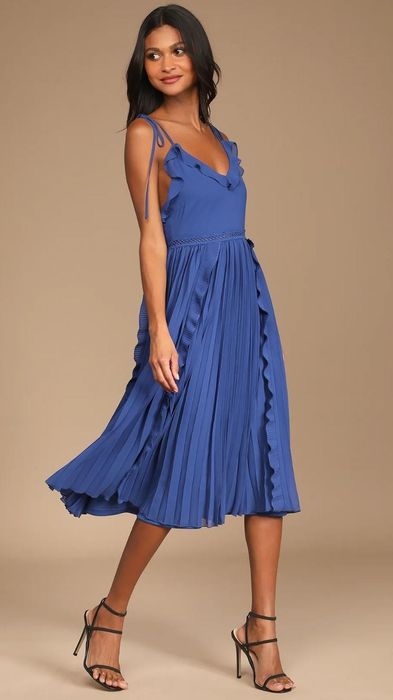 model wearing a striking royal blue tie-strap dress