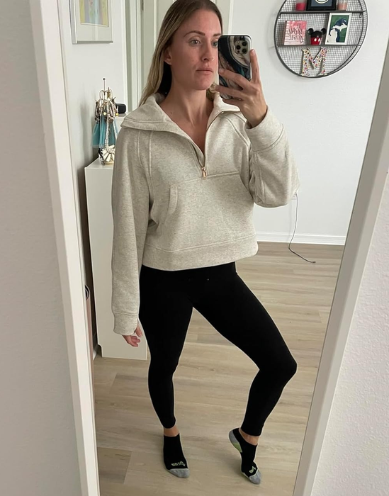 A reviewer showcasing the white sweater