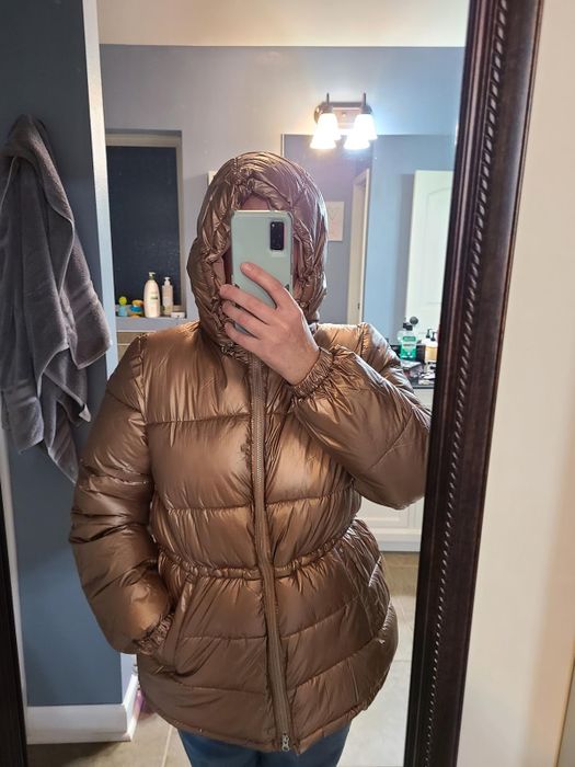 A reviewer wearing the jacket in gold.