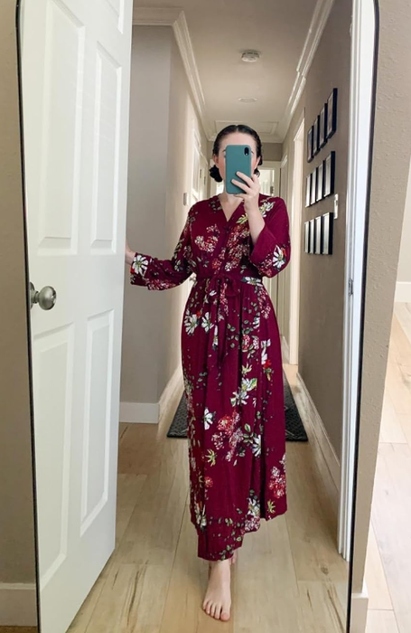 A reviewer in a red floral robe snapping a mirror selfie
