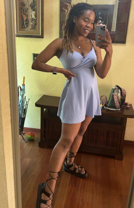 A reviewer snapping a selfie while wearing stylish gladiator sandals