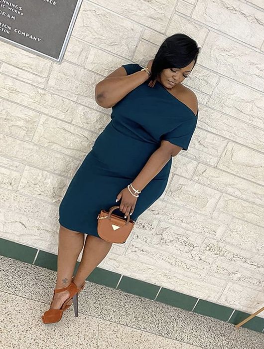 A reviewer wears the green dress, showcasing its vibrant and stylish design