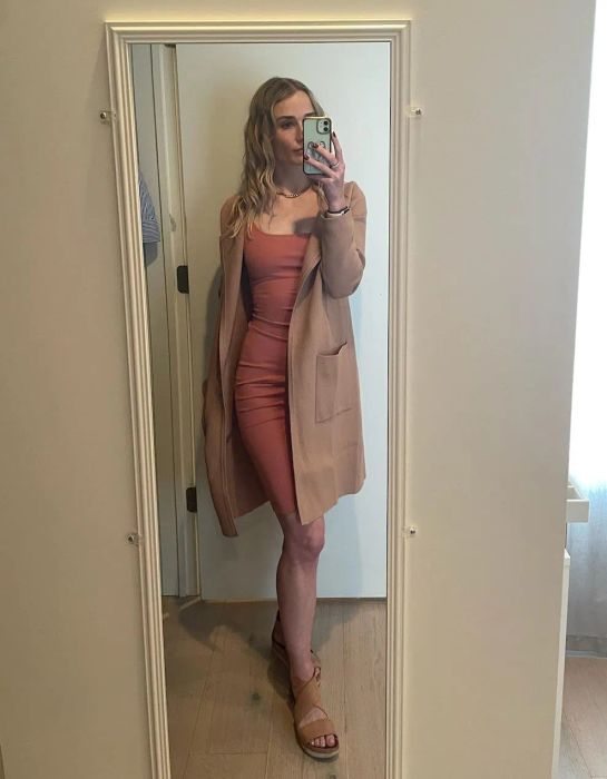 Reviewer styling the khaki cardigan with a dress