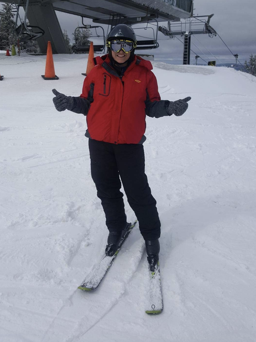 A reviewer dons the jacket in red while skiing down the slopes.