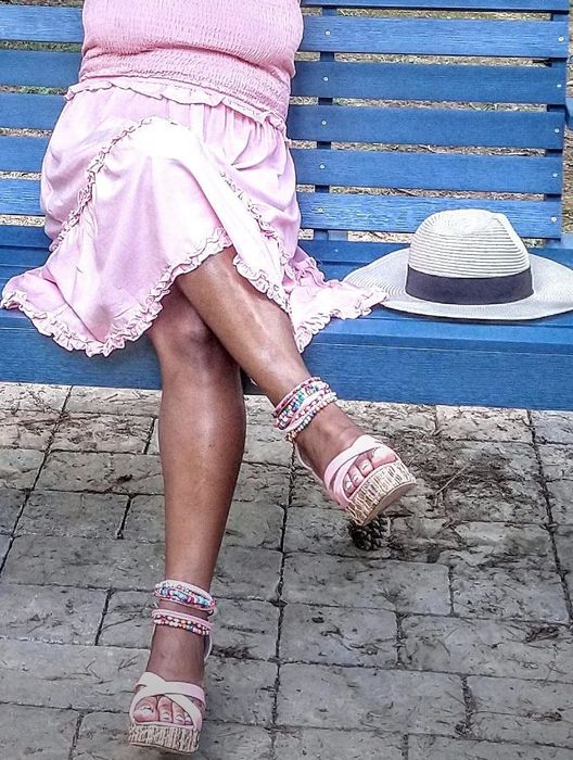 A reviewer wearing elegant beaded sandals