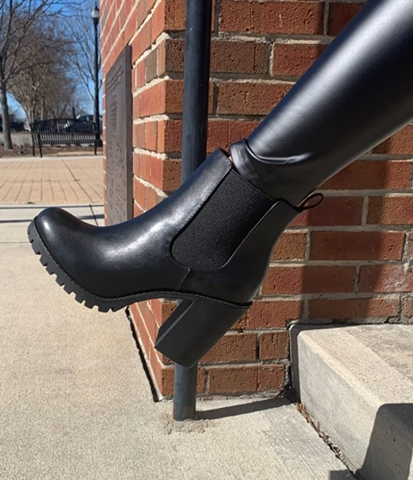 a second reviewer modeling the same stylish black boots