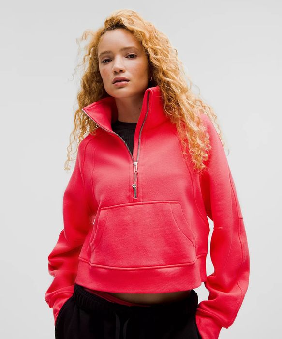 A model confidently posing in a fashionable zip-up sweatshirt with a high collar and front pocket, featured in a shopping article