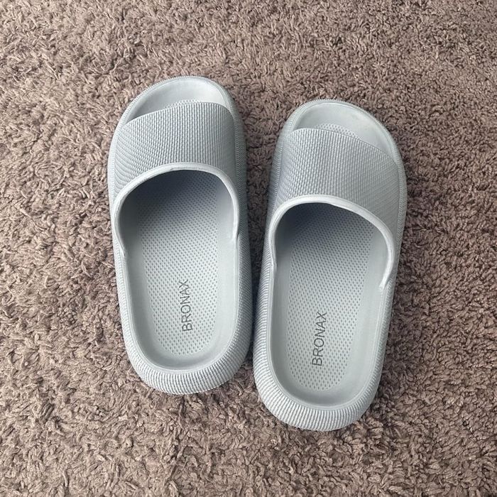 Casual slide sandals placed on a textured surface