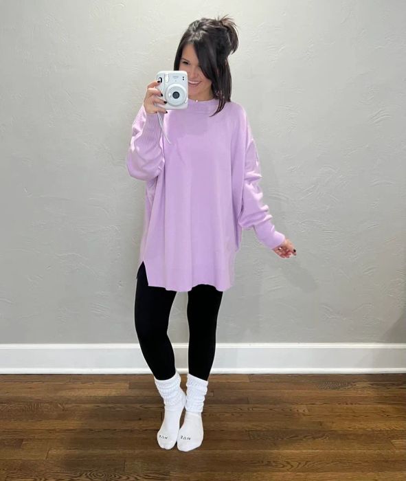 a reviewer wearing the white slouch socks alongside black leggings