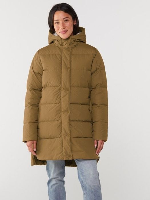 A person wearing the brown version of the same coat, paired with jeans, featured in a shopping article.