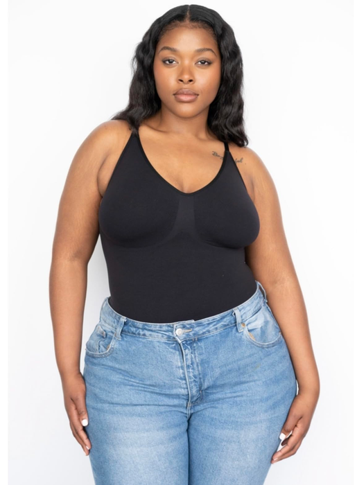 A reviewer wearing the black tank bodysuit paired with blue jeans