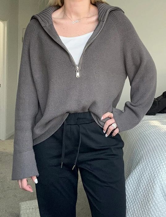 A reviewer wearing the gray sweater