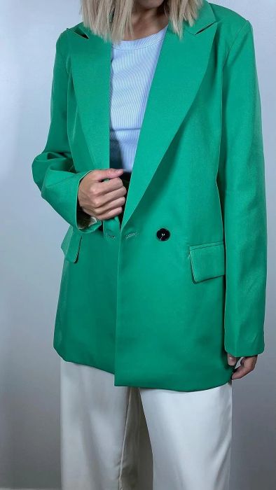 A reviewer styling the green blazer