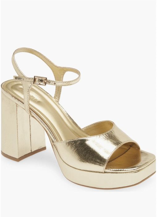 An open-toe platform sandal with a chunky block heel and a secure ankle strap