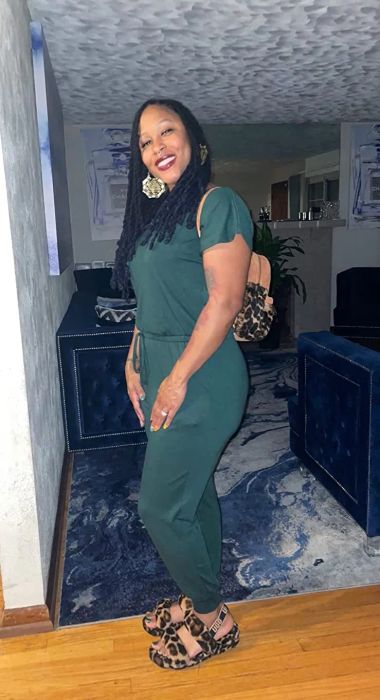 Another reviewer wearing the dark green jumpsuit
