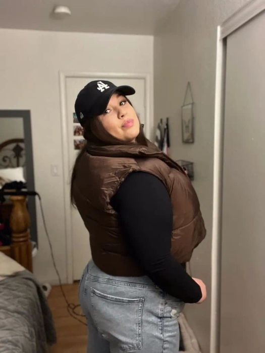 Reviewer wearing the brown puffer vest with a black long-sleeve top