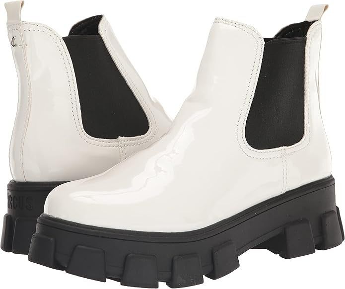 A pair of glossy ankle boots with chunky black soles, highlighted in a shopping feature