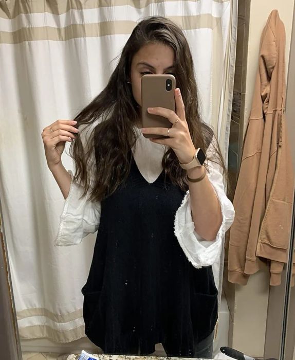 Reviewer styling the black sweater vest