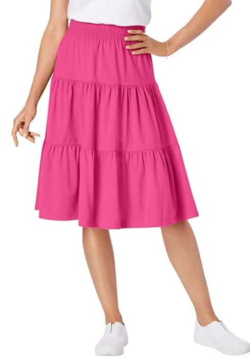 A model wearing a pink tiered skirt