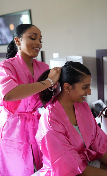 Two reviewers modeling the pink robes