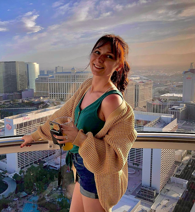 A reviewer modeling the beige cardigan