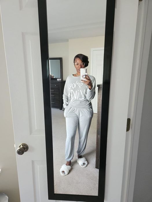 a reviewer snapping a mirror selfie in a cozy gray outfit featuring a long-sleeve top with a