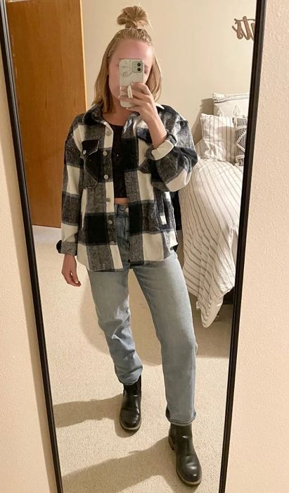 a reviewer styling the plaid shacket in white and navy blue, paired with a crop top and jeans