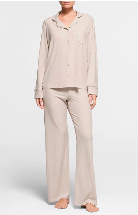 A model wearing a loose-fitting, long-sleeve pajama set