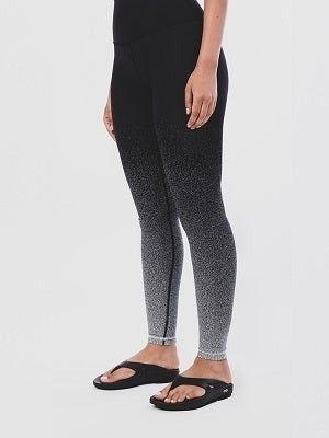 A person dressed in gradient leggings and sandals, highlighting a trendy athleisure look, ideal for a shopping-related article.
