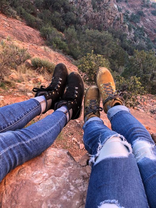 Two reviewers showcasing hiking boots
