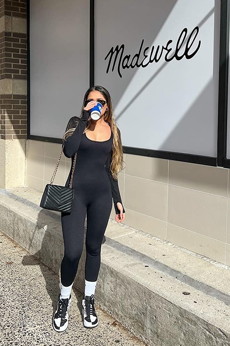 A reviewer modeling the black bodysuit