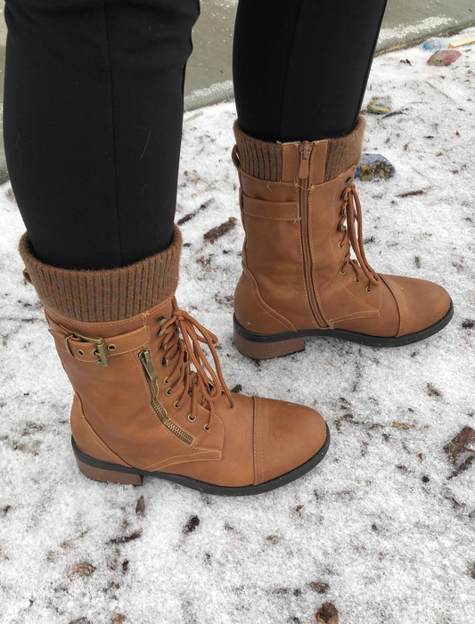 A reviewer modeling the boots in a rich brown shade