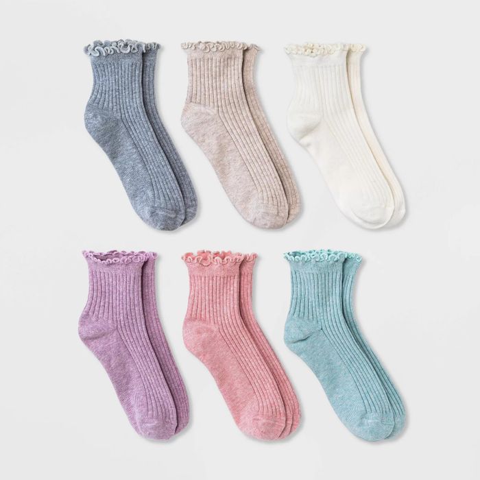Six pairs of ribbed ankle socks with ruffled cuffs, in colors: gray, beige, white, purple, pink, and mint green.