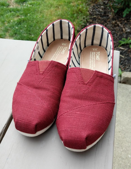 A reviewer’s photo of their red canvas slip-ons