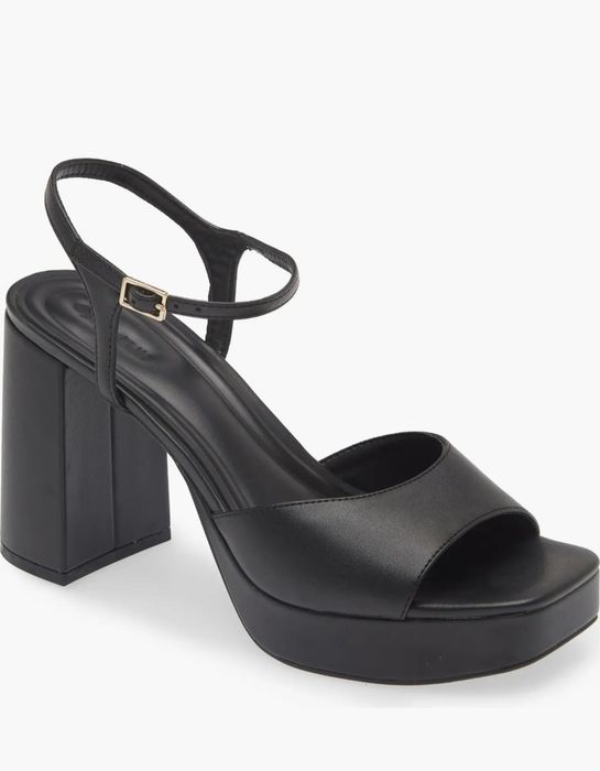 A sleek black platform sandal featuring an open toe, ankle strap, and a high block heel