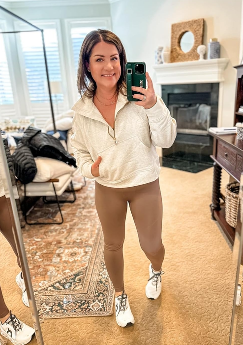 A reviewer showcasing the white sweater