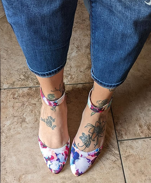 A reviewer wearing floral-patterned flats