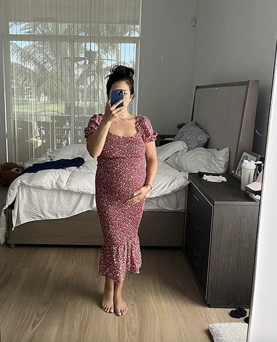 A reviewer models the dress, highlighting its elegant design
