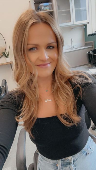 A reviewer showcasing the black top