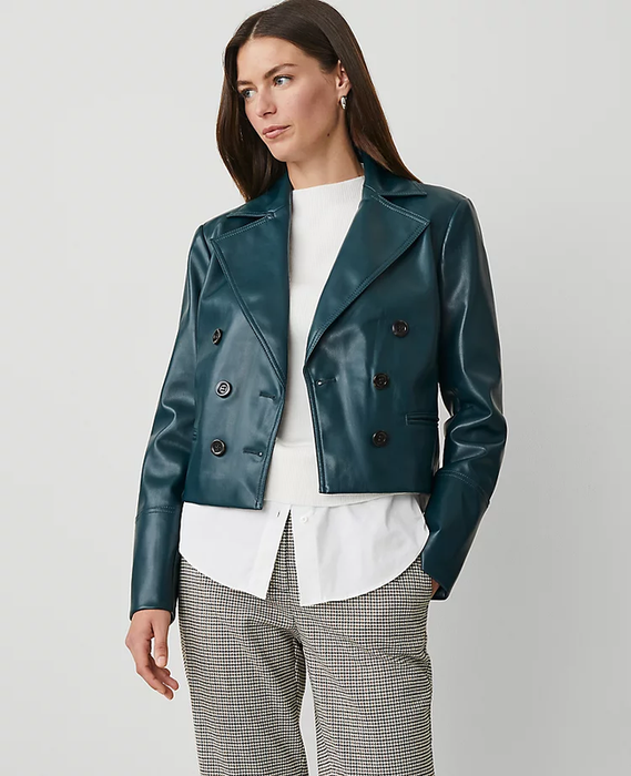 model wearing a double-breasted teal jacket