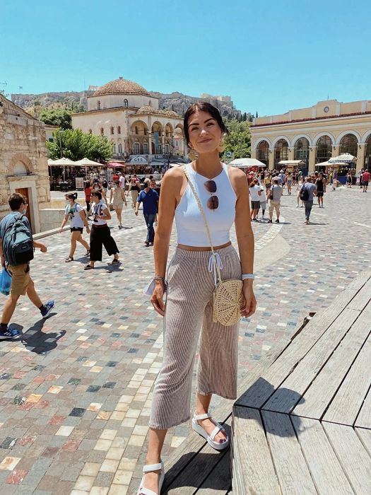 a photo of a reviewer wearing the white tank top