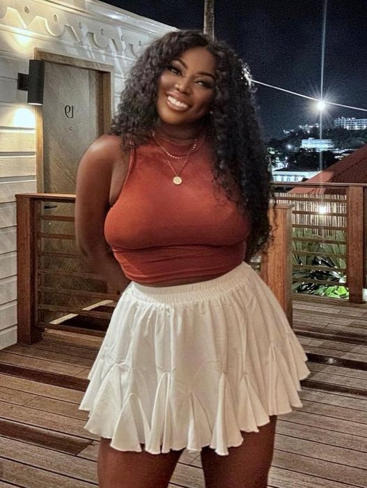 A reviewer showcasing the white skirt