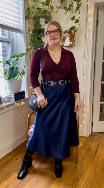 reviewer wearing the navy skirt paired with a burgundy top and black belt