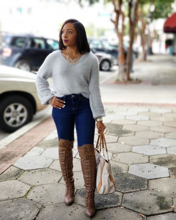 A reviewer wearing the knee-high boots in brown