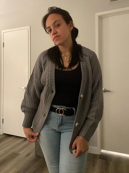 A reviewer showcasing the gray cardigan